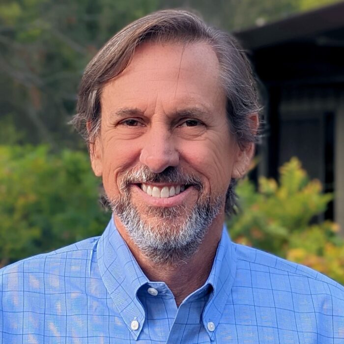 Man in blue shirt smiling