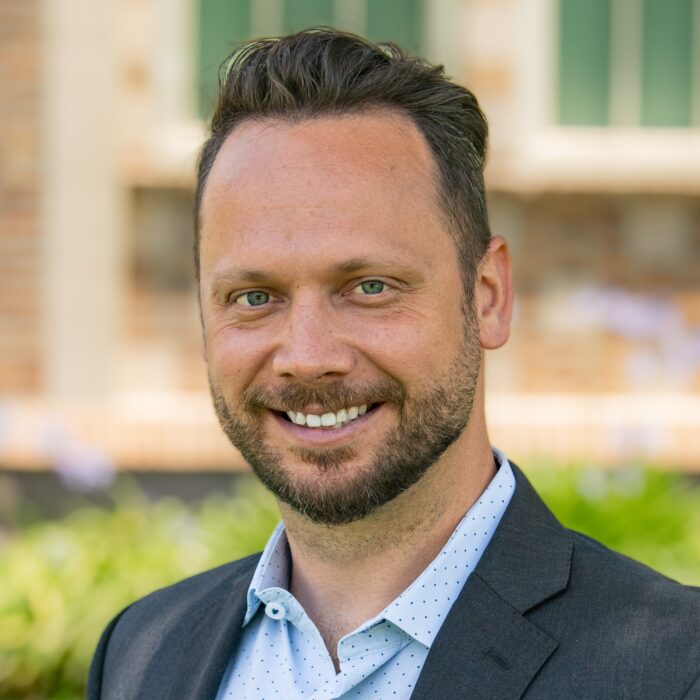 David Lane- Finance VP Man in suit smiling